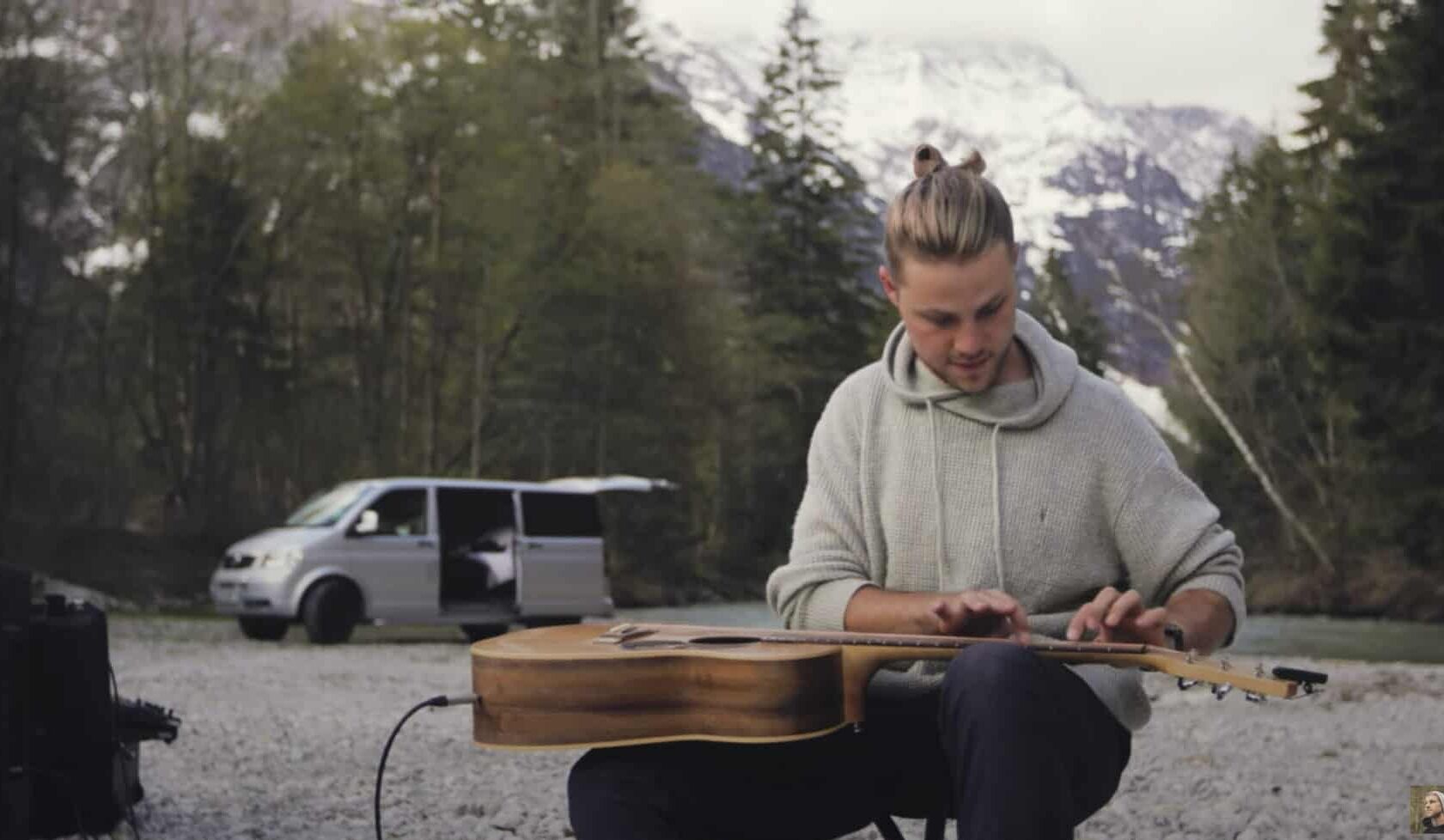 Simeon Baker camping and playing guitar in the Swiss Alps