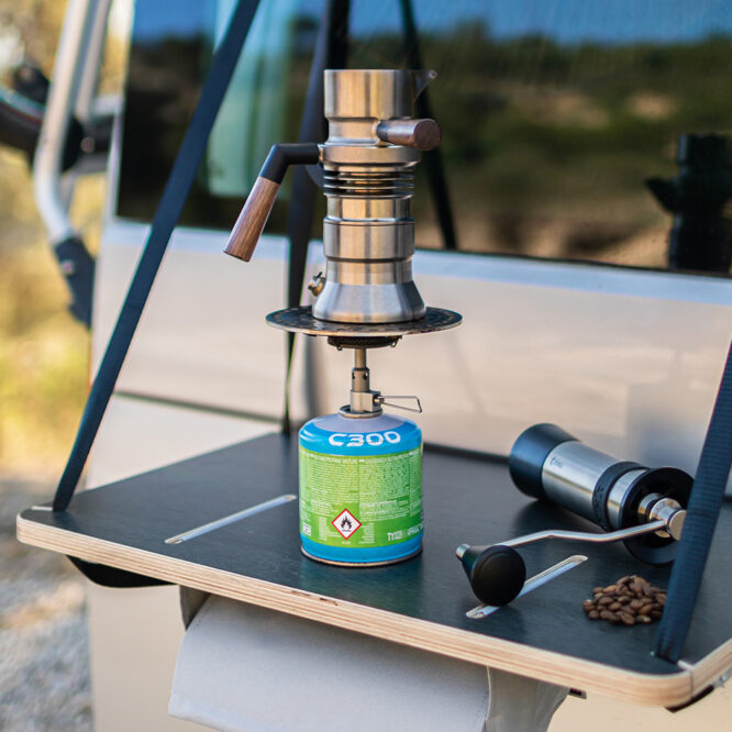 Portable butane camping stove with coffee maker on campervan hanging door table, perfect compact stove for vanlife adventures under £100
