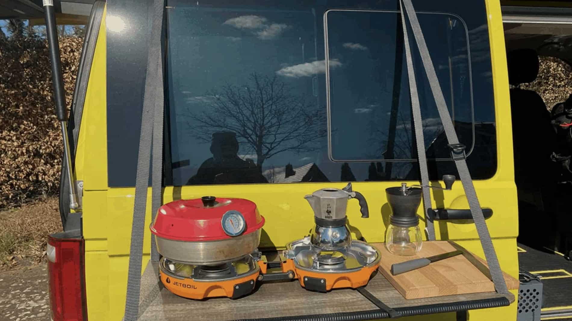 Hanging campervan door table set up outdoors, a practical and budget-friendly accessory featured in our 10 best campervan gifts under £100 guide