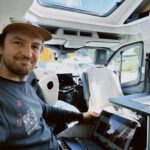 Working remotely from a Sunlight camper van office on a laptop