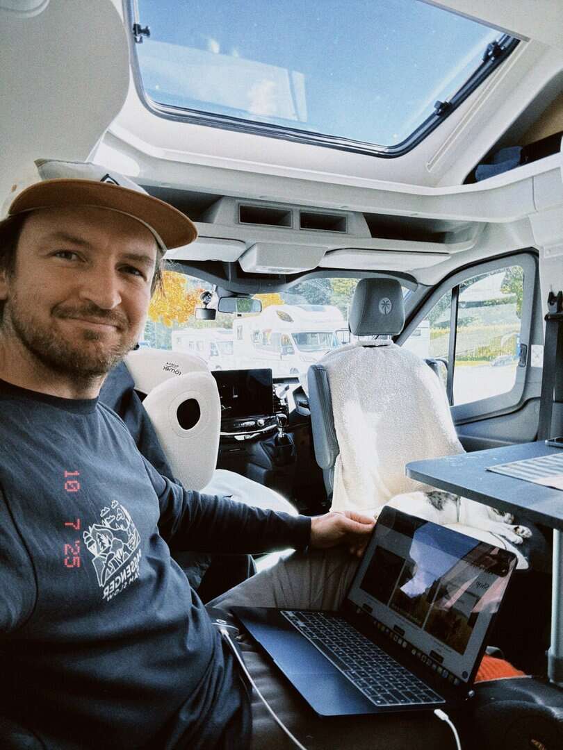 Working remotely from a Sunlight camper van office on a laptop
