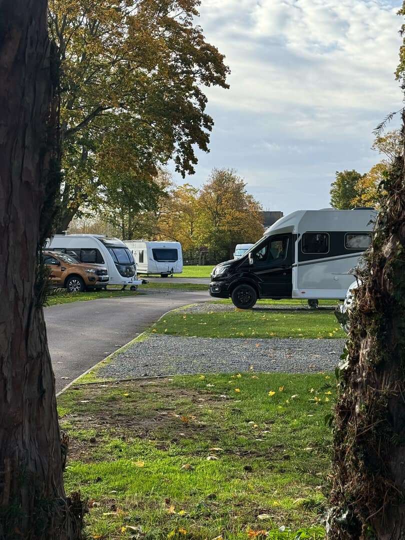 Riverside camping pitches at Chertsey Club Site London with camper vans and motor homes